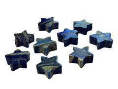Several blue lapis lazuli moon carved crystals 60mm on white background