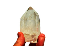 One large rough clear quartz prism 140g on hand with white background