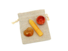 Small carnelian sphere, orange calcite point and yellow hematoid quartz heart on small bag