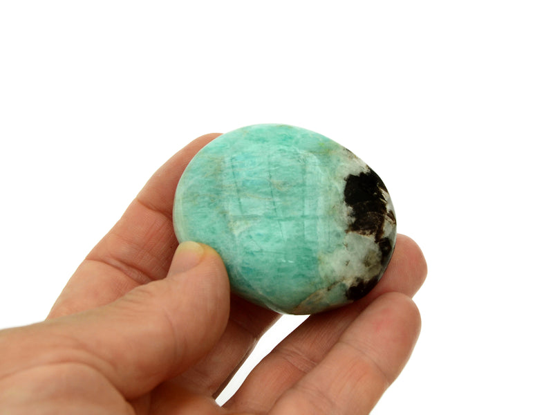 One large green amazonite tumbled crystal on hand with white background
