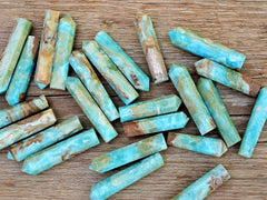 Several blue aragonite faceted crystal points 50mm on wood table