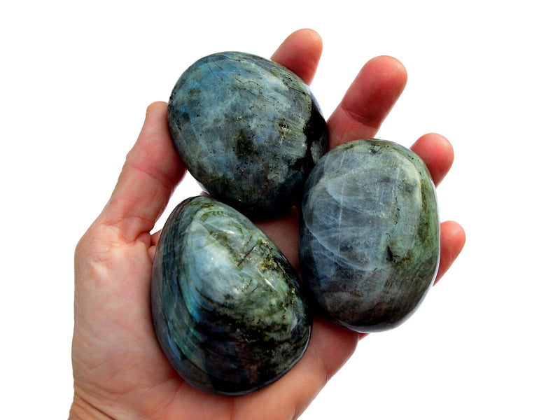 Three big blue labradorite tumbled minerals on hand with white background