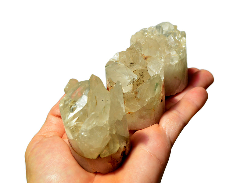 Three crystal quartz cluster cylinders 40mm-50mm on hand with white background
