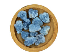 Several small rough celestite crystal cluster 40mm-500m inside a wood bowl on white background