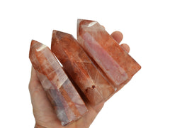 Three fire quartz towers 100mm on hand with white background