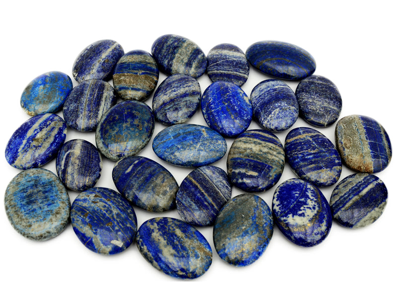Several natural lapis lazuli oval palmstones 55mm-75mm on white background