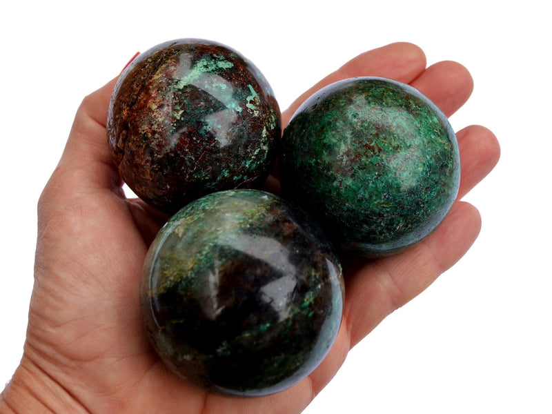 Three chrysocolla crystal spheres 65mm-65mm on hand with white background