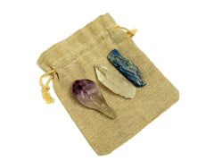 One raw amethyst point, raw clear quartz point and raw blue kyanite on small bag