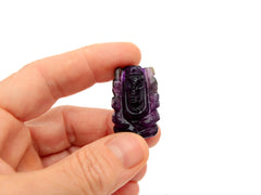 One mini amethyst ganesha esculpture 35mm on hand with white background