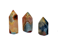 Three short desert jasper tower crystals on white background