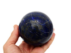 Lapis lazuli sphere 80mm on hand with white background