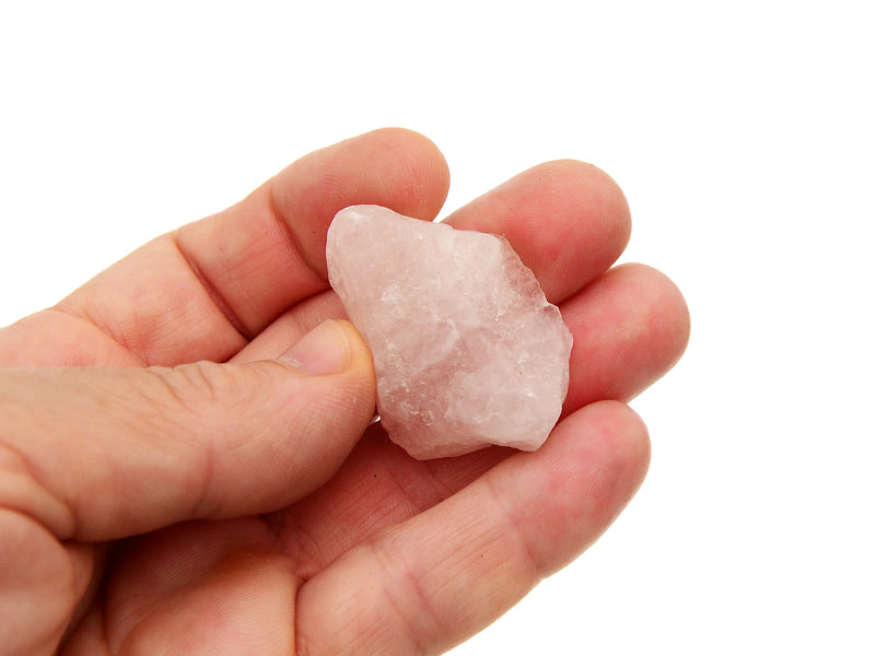 Rough pink quartz stone 30mm on hand with white background
