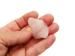 Rough pink quartz stone 30mm on hand with white background