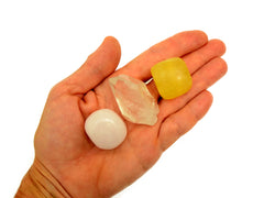 Pink mangano tumbled, raw clear quartz point and lemon calcite tumbled stone 20mm-30mm on hand with white background