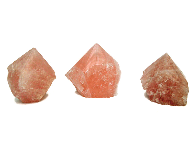 Three semi polished pink quartz points 70mm-80mm on white ackground