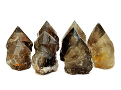 Nine smoky quartz semi polished points 65mm-90mm on white background