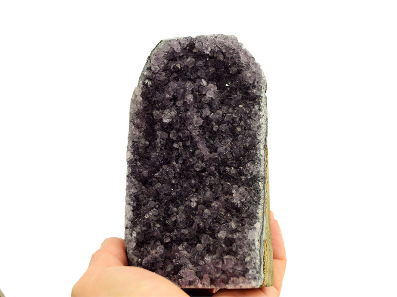 One large purple druzy amethyst stone cut base 122mm on hand with white background