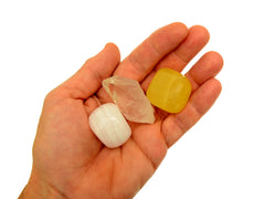 Yellow calcite tumbled, raw clear quartz point and pink mangano calcite tumbled 20mm-30mm on hand with white background