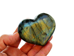 One green labradorite heart stone 55mm on hand with white background