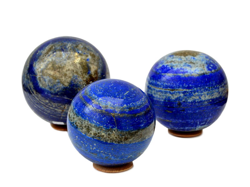 Three large lapis lazuli spheres 90mm-120mm on white background