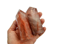 Two large fire quartz towers on hand with white background