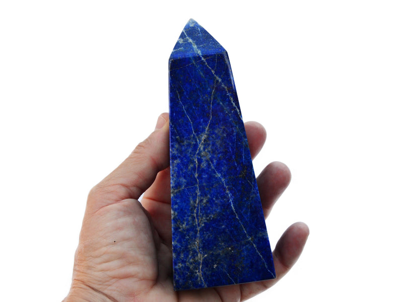 One large lapis lazuli tower 140mm on hand with white background