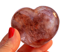 One big fire quartz heart crystal 67mm on hand with white background