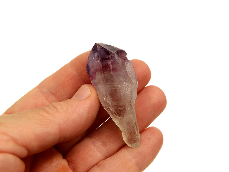 One raw amethyst point 50mm on hand with white background