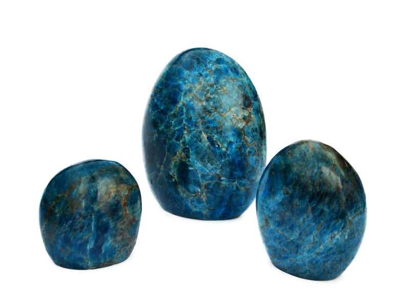 Three blue apatite free form gemstones 75mm-130mm on white background