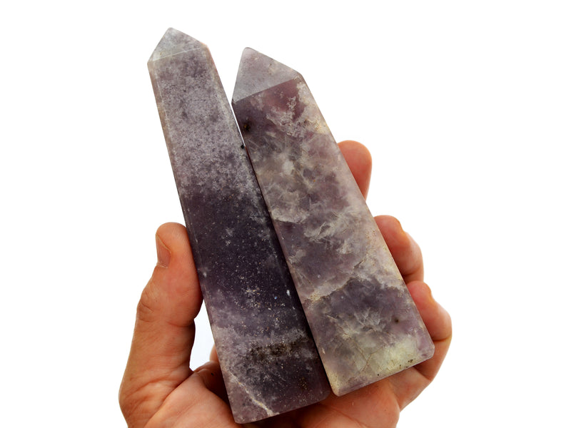 Two lepidolite tower crystals 100mm-105mm on hand with white background