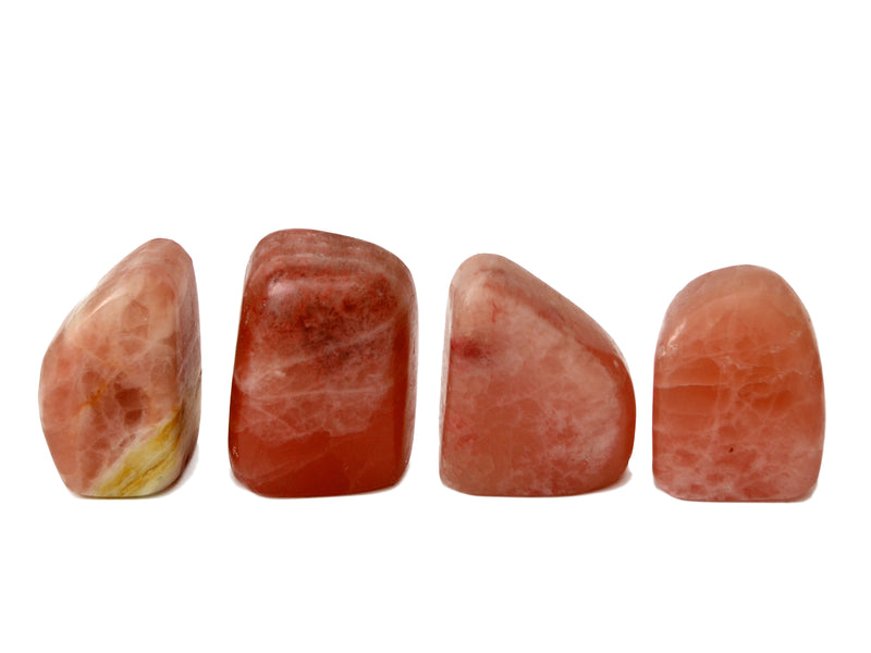 Four rose calcite free forms 50mm on white background