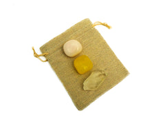 Yellow calcite tumbled, raw clear quartz point and tumbled mangano calcite 20mm-30mm on hand with white background