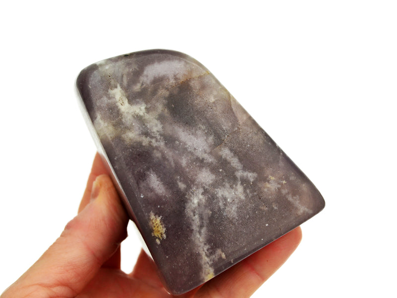 One chunky lepidolite free form mineral on hand with white background