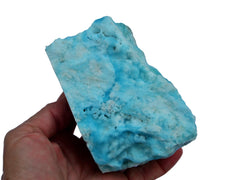 One large blue aragonite mineral rock raw on hand with white background