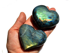 Two large labradorite hearts 70mm on hand with white background