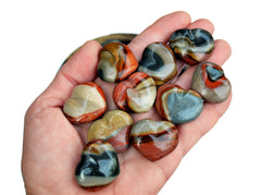Ten polychrome jasper crystal hearts small 30mm on hand with white  background 