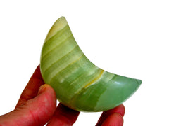 One pistachio calcite moon crystal 70mm on hand with white background