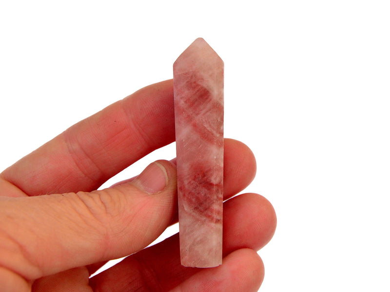 One rose calcite crystal point 65mm on hand with white background