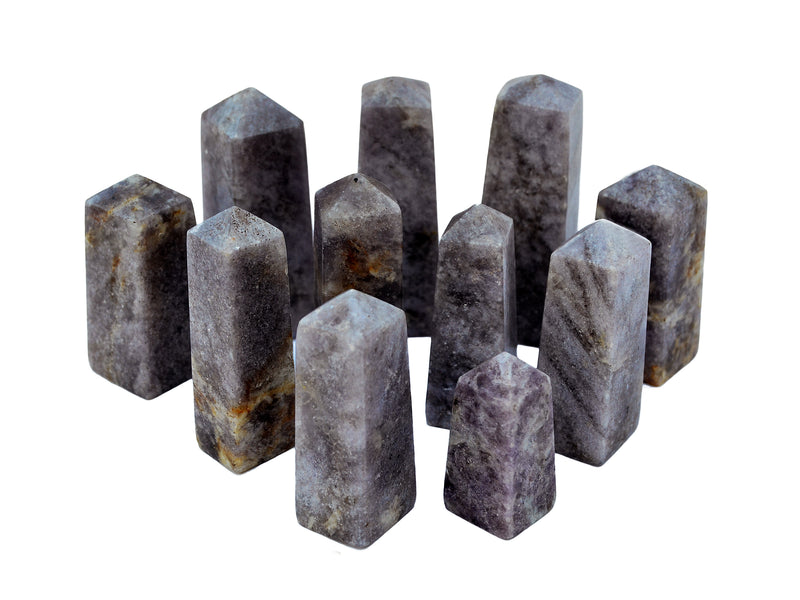 Several lepidolite crystal obelisks  40mm-75mm on white background