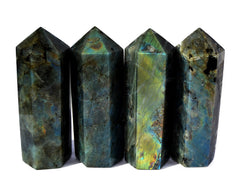 Four flashy labradorite faceted crystal points 110mm on white background