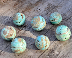 Some blue aragonite sphere stones 70mm on wood table