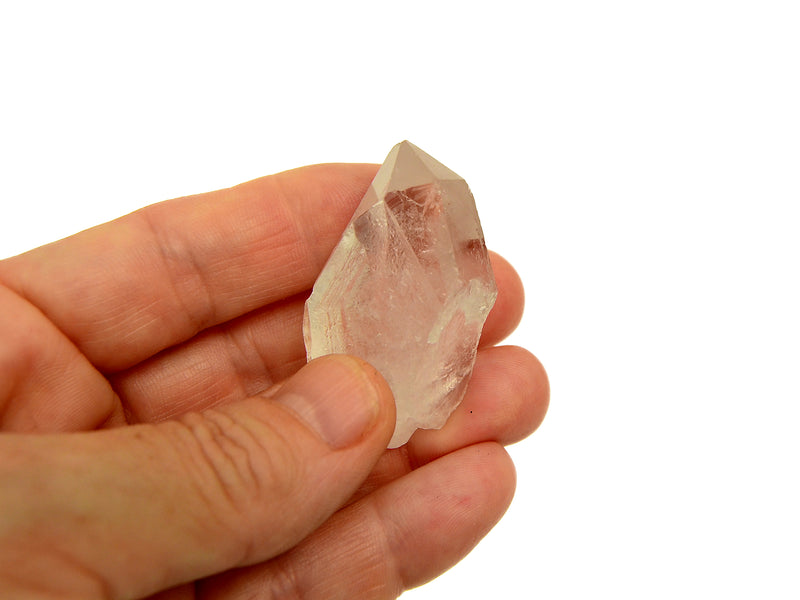 One raw clear quartz point 30mm on hand with white background