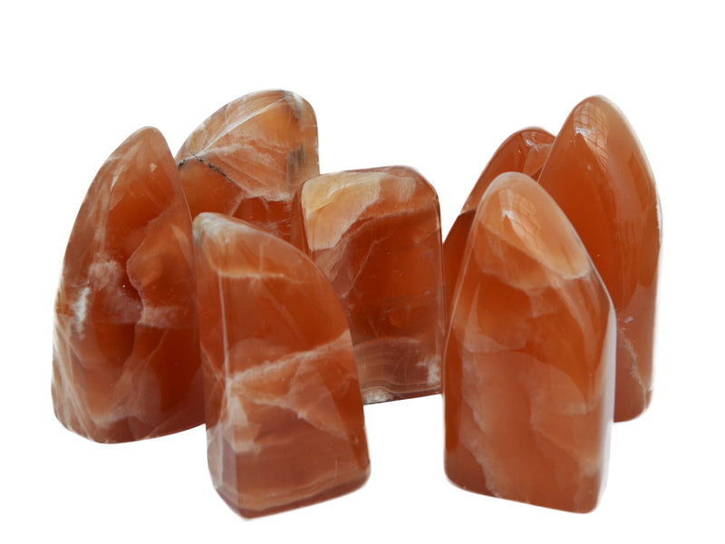 Some honey calcite free form minerals 80mm-140mm on white background