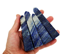 Four lapis lazuli obelisk stones 110mm on hand with white background