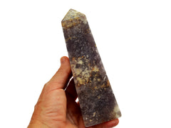 One chunky purple lepidolite obelisk crystal 145mm on hand with white background