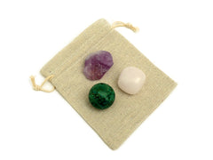 One tumbled mangano calcite, raw amethyst and chrycolla sphere 30mm on small bag