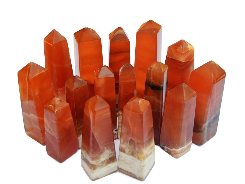 Several banded honey calcite crystal towers 85mm-100mm on white background