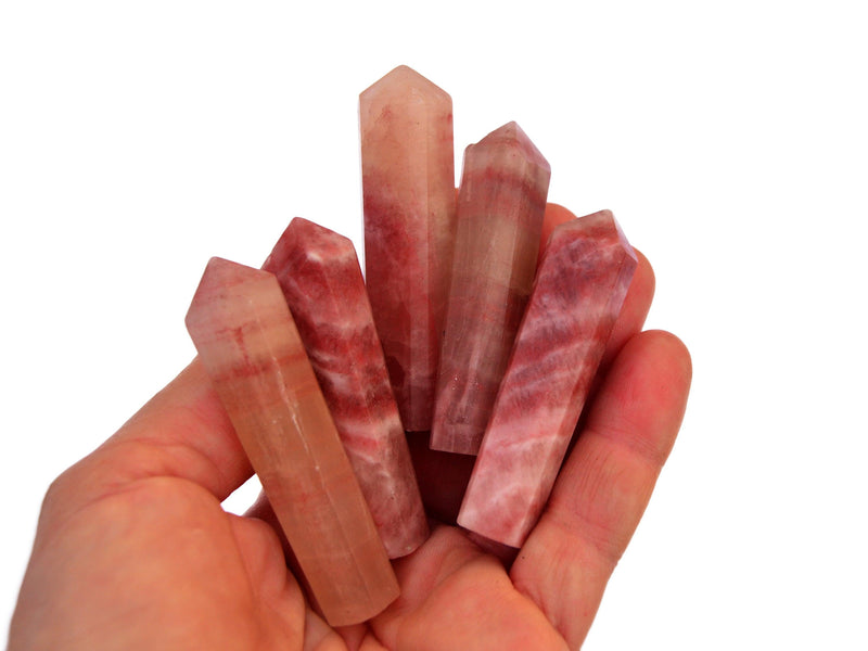 Five rose calcite small towers 55mm-65mm on hand with white background