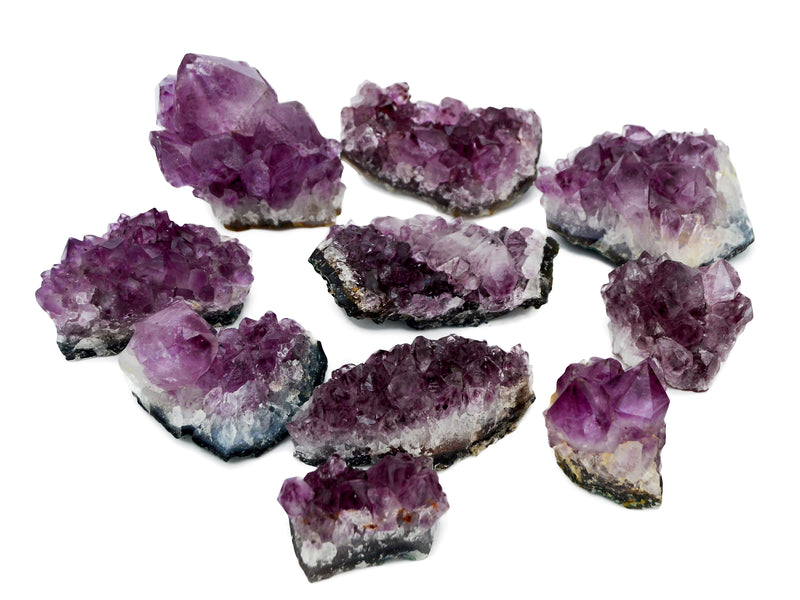 Ten brazilian amethyst raw crystals 50mm-110mm on hand with whte background
