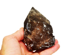 One semi polished smoky quartz stone 90mm on hand with white background